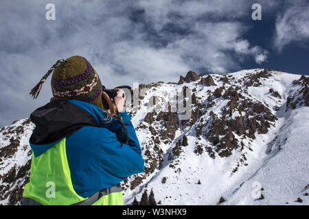Nature Photography Concept. Professional photographer takes photos of rock peak. Winter landscape. Stock Photo