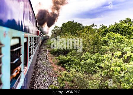 View of the very beautiful Konkan region from the window side while traveling in the sleeper class diesel engine train of Indian Railways. Stock Photo
