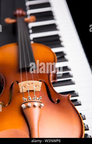 Violin on the piano on a black background Stock Photo
