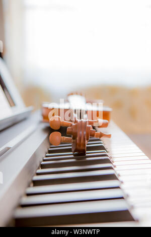 The violin lies on keys digital piano Stock Photo