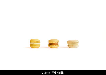 Three macaroons on an isolated background with space for your text. Stock Photo