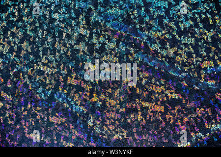 Dark fabric with folds and holographic elements. Abstract geometric background or texture. Stock Photo