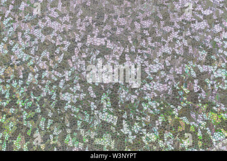 Silvery holographic fabric with folds. Abstract geometric background or texture. Stock Photo