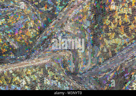 Golden holographic fabric with folds. Abstract geometric background or texture. Stock Photo