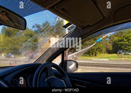 Time to wash the car, rinsing it off Stock Photo
