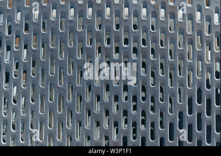 A silver metal grill with rounded holes in lines Stock Photo