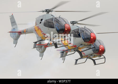 Patrulla ASPA are the Spanish Air Force helicopter aerobatic display team, flying Eurocopter EC-120 Colibri helicopters. Tight formation flying Stock Photo