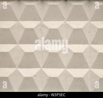 Part of a light concrete fence with rhombuses. Stock Photo