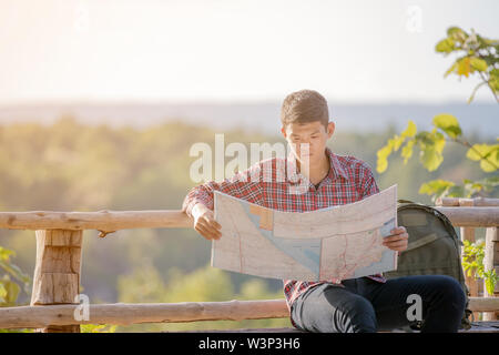 Man tourist in mountain read the map. Tourism concept Stock Photo