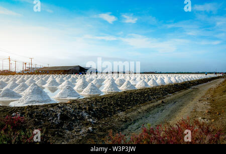 Sea salt farm and barn in Thailand. Organic sea salt. Raw material of salt industrial. Sodium Chloride. Solar evaporation system. Iodine source. Stock Photo