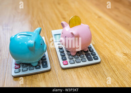 Bitcoin and two piggybank put on calculator on wooden background Stock Photo