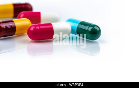 Colorful antibiotic capsule pills on white background. Pharmaceutics concept. Antibiotic drug resistance. Pharmaceutical industry. Pharmacy drugstore. Stock Photo