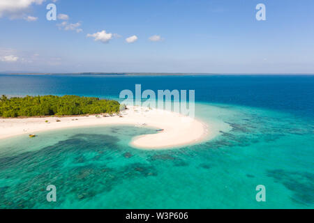 Patawan island. Small tropical island with white sandy beach. Beautiful island on the atoll, view from above. Nature of the Philippine Islands. Stock Photo