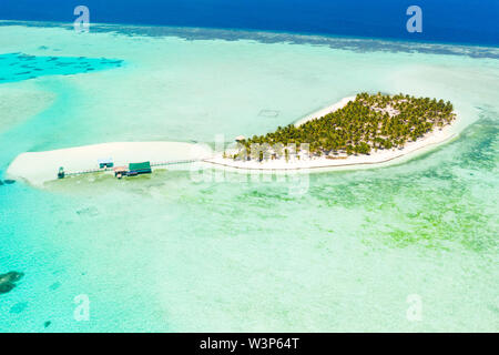 Seascape with a paradise island. Onok Island Balabac, Philippines. A small island with a white sandy beach and bungalows. Philippine Islands. Stock Photo