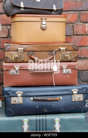 Stack of old suitcases on a market stall for sale Stock Photo