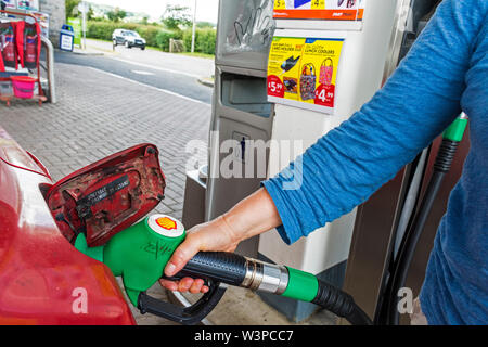 Filling car tank with unleaded petrol at Shell service station, Box, Somerset, UK Stock Photo