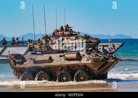 Australian Army soldiers with the 2nd Battalion, The Royal Australian Regiment, aboard a light armored vehicle-25, come off a landing craft onto Langham Beach, Queensland, Australia, July16, during Exercise Talisman Sabre 2019. Talisman Sabre 19 is a bilateral exercise that provides U.S. and Australian forces realistic and relevant training to strengthen regional security, peace and stability. (U.S. Army Photo by Sgt. 1st Class Whitney C. Houston) Stock Photo