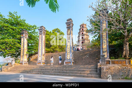Tourists sightseeing pilgrimage Thien Mu pagoda in sunny morning, this is the oldest temple in Hue, Vietnam Stock Photo