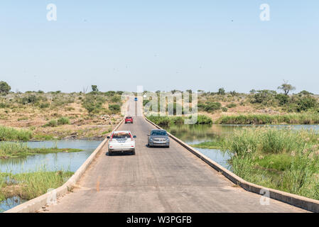 KRUGER NATIONAL PARK, SOUTH AFRICA - MAY 4, 2019: The low level bridge over the Sabie River near Lower Sabie in the Kruger National Park. Vehicles are Stock Photo