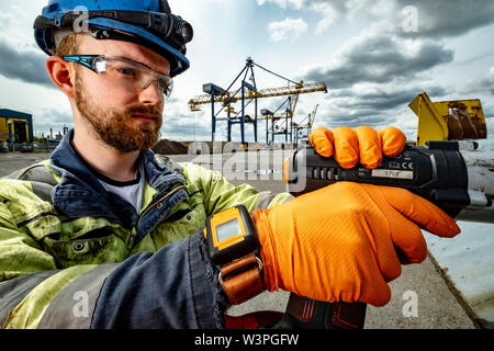Skilled workers using power tools Stock Photo