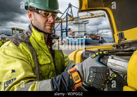 Skilled workers using power tools Stock Photo