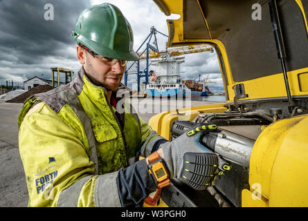 Skilled workers using power tools Stock Photo