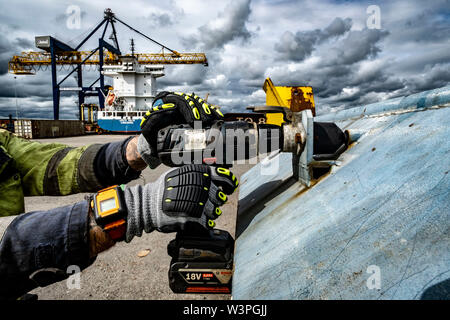 Skilled workers using power tools Stock Photo