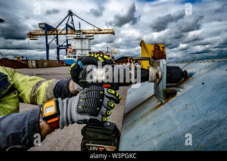 Skilled workers using power tools Stock Photo
