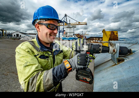 Skilled workers using power tools Stock Photo