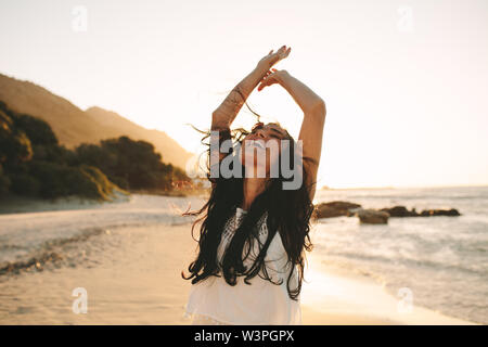 Beautiful woman enjoying a summer day on the beach. Caucasian female having a great time on her vacation. Stock Photo
