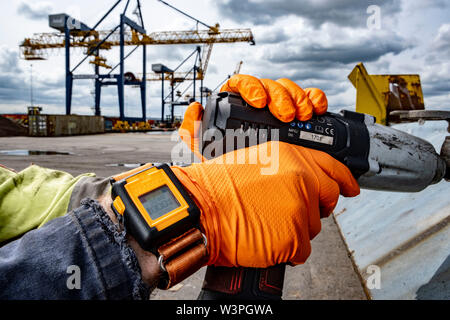 Skilled workers using power tools Stock Photo