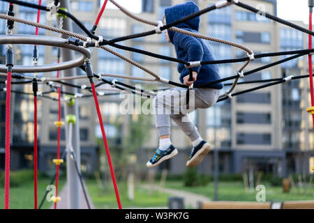 a little boy is having fun playing on the modern urban European playground Stock Photo