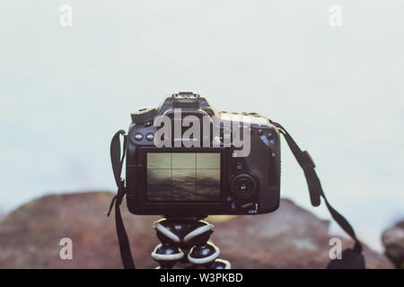 camera on a gorilla pod taking pictures of a landscape Stock Photo