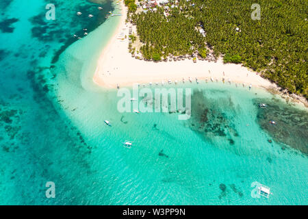 Beautiful tropical island in sunny weather, view from above. Daco island, Philippines. White sandy beach and turquoise lagoon.