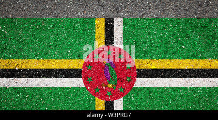 National flag of Dominica on a stone background.The concept of national pride and symbol of the country. Stock Photo