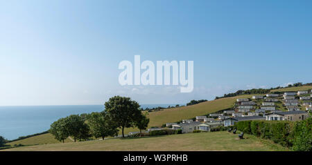 Beer, Seaton, Devon, England, UK.   Caravan park at Beer Head on high ground and overlooking the sea with a clear blue sky. Stock Photo