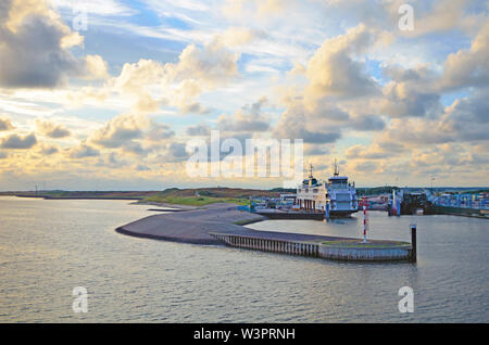 Large retired double ended passanger and car ferry by company TESO called 'Schulpengat' in harbor '’t Horntje' at sunset Stock Photo