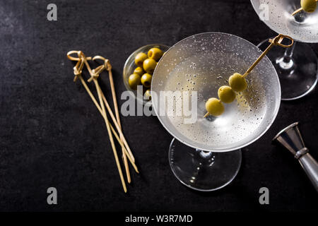 Classic Dry Martini with olives on black background.Copyspace Stock Photo