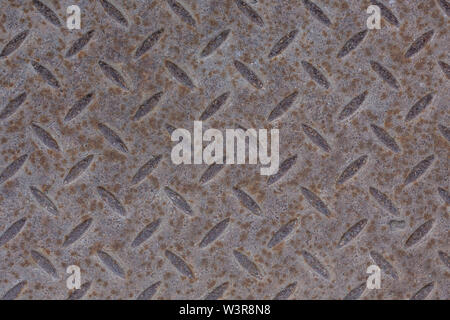 Industrial wallpaper of functional anti-slip metal diamond plate and rough raised surface pattern. Creative background macro of construction. Stock Photo