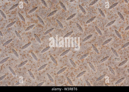 Industrial wallpaper of functional anti-slip metal diamond plate and rough raised surface pattern. Creative background macro of construction. Stock Photo