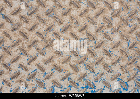 Industrial wallpaper of functional anti-slip metal diamond plate and rough raised surface pattern. Creative background macro of construction. Stock Photo