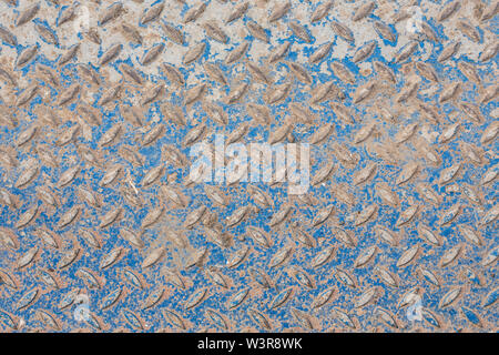 Industrial wallpaper of functional anti-slip metal diamond plate and rough raised surface pattern. Creative background macro of construction. Stock Photo