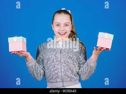 Pick bonus. Special happens every day. Girl with gift boxes blue background. Black friday. Shopping day. Cute child carry gift boxes. Surprise gift box. Birthday wish list. World of happiness. Stock Photo