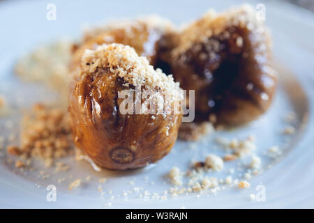 caramelized figs with walnut, served as a dessert, close up Stock Photo