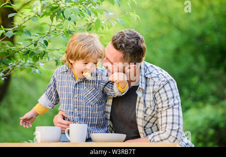 Nutrition habits. Family enjoy homemade meal. Family time. Nutrition kids and adults. Little boy and dad eat. Everything is more fun with father. Organic nutrition. Healthy nutrition concept. Stock Photo