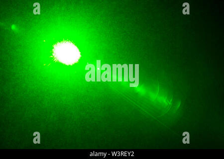 Camera lens flare by laser light create circles of objective iris shapes of number depending on number of lens surface and interference effect. Stock Photo