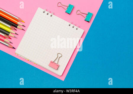 Stationery. School and office supplies on a blue and pink colored background. Selective focus.Advertising space Stock Photo