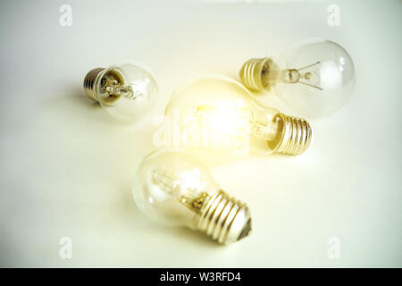 Light bulb lamps on white background one glowing concept of one special idea