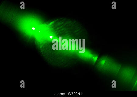 Camera lens flare by laser light create circles of objective iris shapes of number depending on number of lens surface and interference effect. Stock Photo