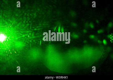 Camera lens flare by laser light create circles of objective iris shapes of number depending on number of lens surface and interference effect. Stock Photo